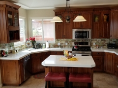Grand Contrasting White Countertops against Hazel Cabinets
